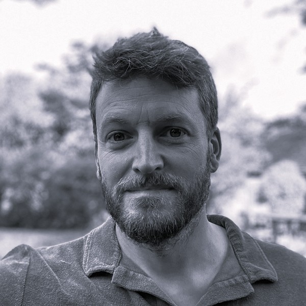 A headshot of Jack Stolgoe in black and white.